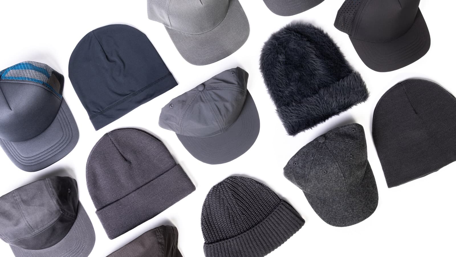 Flat lay of grey blank caps and beanies from the PAG signature shapes line